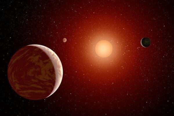 This artist's concept illustrates a young, red dwarf star surrounded by three planets.